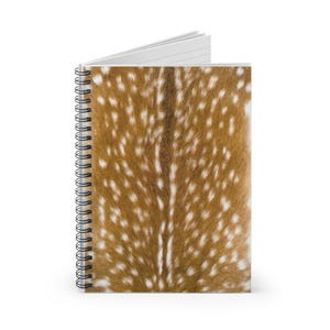May include: Spiral-bound notebook featuring a brown and white spotted pattern, resembling animal fur. The notebook has a white interior and a black spiral binding. The cover design is a close-up of the spotted pattern.