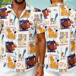 May include: White button-down shirt featuring a colorful pattern of characters from The Lion King. The design includes Simba, Pumbaa, Timon, and Zazu, along with geometric shapes. The shirt has short sleeves and a classic collar.