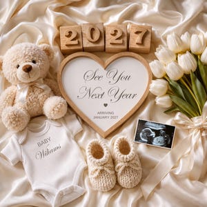 May include: A beige teddy bear, a heart-shaped wooden sign with the text See You Next Year Arriving January 2027, four wooden blocks displaying 2027, a white baby bodysuit with Baby Williams, cream knit booties, and white tulips with an ultrasound.