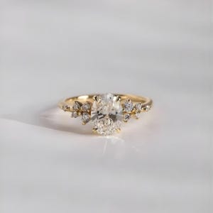 Floral Diamond Ring with oval center stone and round accents.