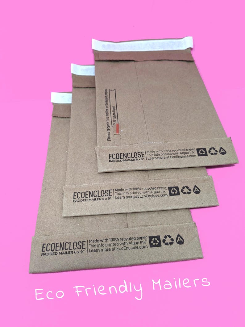 May include: Three brown padded mailers with white tape seals. The mailers are stacked on top of each other. The mailers are made with 100% recycled paper and printed with algae ink. The mailers are 6 x 9 inches. The text "ECOENCLOSE" and "PADDED MAILER 6 x 9" is printed on the mailers. The text "Eco Friendly Mailers" is printed below the mailers.