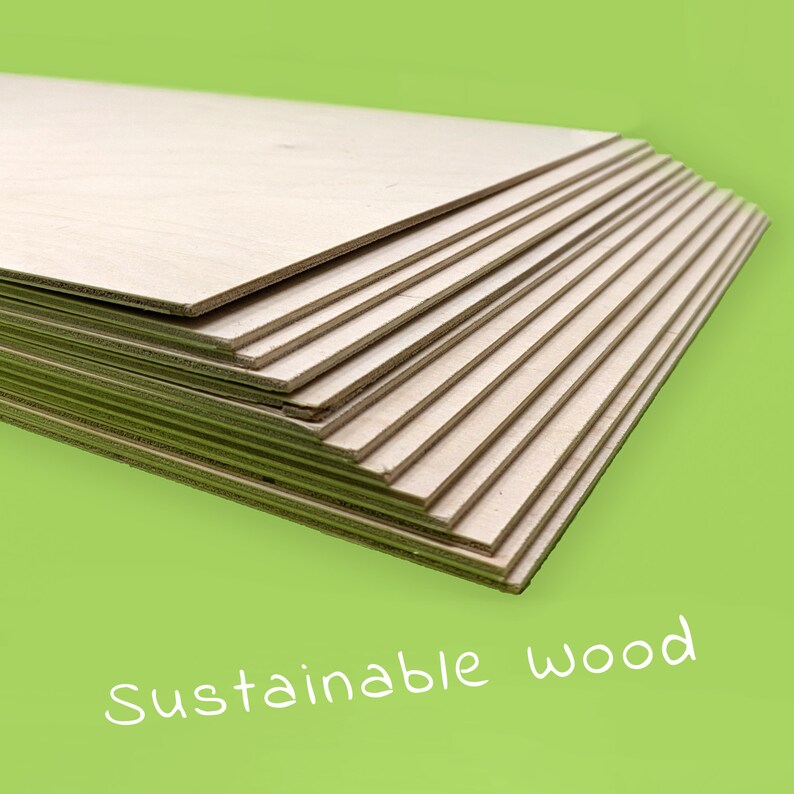 May include: A stack of light-colored wooden boards, possibly plywood or similar material, with visible grain. The boards are neatly arranged, with the text "Sustainable wood" in white script on a green background.