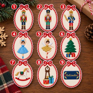May include: Nine oval embroidered ornaments with red scalloped borders and bows. Designs include three nutcrackers, a ballerina in blue, a fairy in gold, a Christmas tree with gifts, a rocking horse, a clock with toys, and a sign reading Nutcracker.