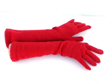 May include: A pair of long red knit gloves. The gloves are made of a soft, stretchy material and have a ribbed texture.