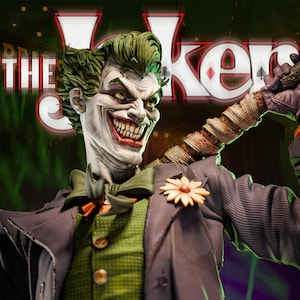 May include: A detailed statue of The Joker, with green hair and a sinister grin. He wears a purple pinstripe suit, green vest, and a flower on his lapel. The background features the words "THE Joker" in a neon sign.