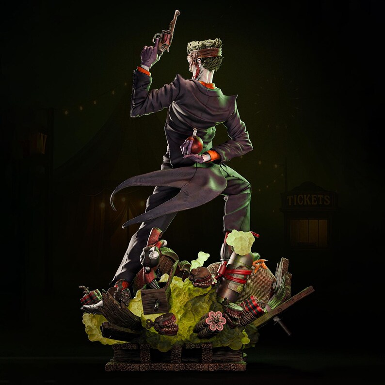 May include: A detailed statue of the Joker, a DC Comics villain, in a dynamic pose. He wears a purple suit with an orange undershirt, holding a gun and a red bomb. The base features a chaotic scene with various props and a green, toxic-looking substance.