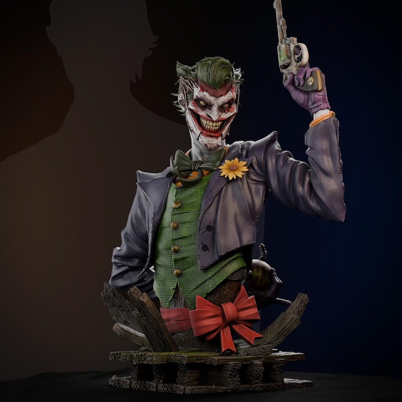 May include: A detailed bust of the Joker, featuring a green vest, purple jacket, and a red bow. The figure holds a gun and has a sinister grin. A yellow flower adorns the lapel. The bust is set on a wooden base.
