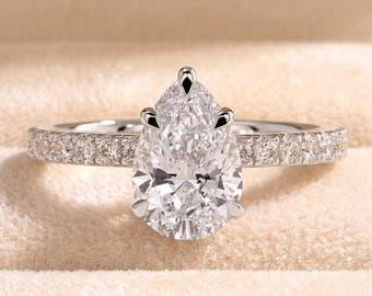 Anello di fidanzamento con taglio a goccia, diamante sintetico da 2 carati che circonda un alone nascosto, fascia pavé, solitario in oro