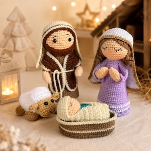 May include: A crocheted nativity scene featuring Joseph, Mary, baby Jesus in a manger, and a sheep. Joseph wears a brown robe and Mary a purple dress. The figures are handmade with detailed stitching and soft textures, perfect for holiday decor.