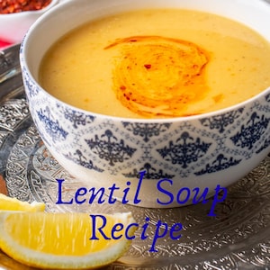 Peut inclure: Un bol de soupe de lentilles avec un tourbillon d'huile rouge, servi sur un plateau argenté décoratif avec un quartier de citron. Le bol a un motif bleu et blanc. Le texte sur l'image indique "Lentil Soup Recipe".