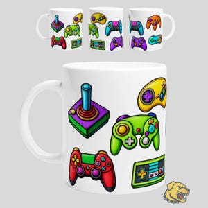 May include: A white ceramic mug featuring a colourful pattern of various video game controllers and a joystick. The design includes a red controller, a green controller, a yellow controller, and a purple joystick, all illustrated in a vibrant cartoon style.