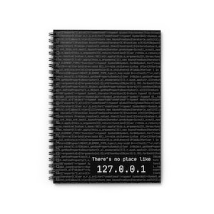 May include: A spiral-bound notebook with a black and white cover. The cover features lines of computer code and the text "There's no place like 127.0.0.1". The notebook is designed for note-taking and journaling.