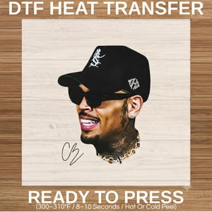 May include: A DTF heat transfer graphic featuring a portrait of a person wearing a black baseball cap with white embroidery, black sunglasses, and a gold chain. The text reads DTF HEAT TRANSFER and READY TO PRESS (300-310°F / 8-10 Seconds).