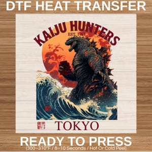 May include: DTF heat transfer with a monster design, reminiscent of Godzilla, rising from ocean waves against a red sun. The text reads "KAIJU HUNTERS EST. 1988" and "TOKYO". Ready to press.