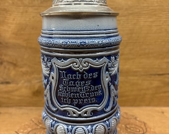 This is an Antique German ceramic beer stein/ mug.
