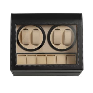 May include: A black watch display case with a clear glass top. The case has two circular watch winders with beige cushions and a lower compartment with five watch pillows. White stitching outlines the edges.