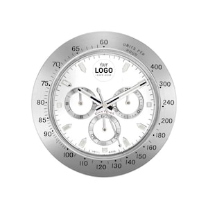 May include: A silver wall clock with a white face, featuring three sub-dials and black hands. The clock face includes the text "DAYTONA" and "YOUR LOGO GOES HERE". The outer ring displays numbers and markings for time measurement.