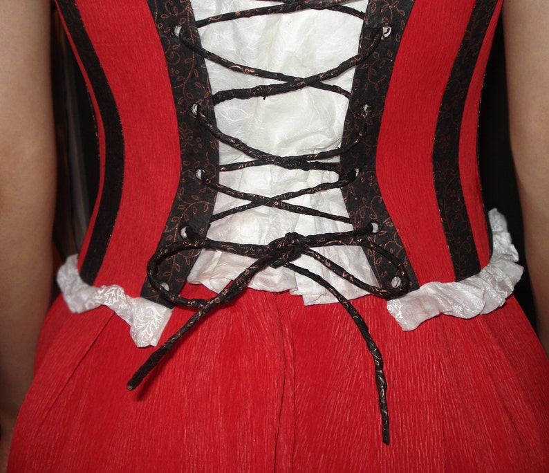 May include: A red dress with black and white trim and a black lace-up corset back.