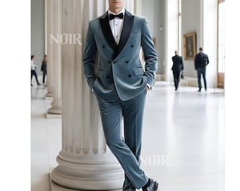 May include: A teal velvet double-breasted suit with a black satin lapel, worn with a white dress shirt and black bow tie. The suit is paired with black leather dress shoes. The word "NOIR" is printed on the image.