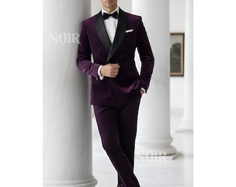 May include: A formal purple velvet suit with a black satin lapel and a white dress shirt. The suit includes a double-breasted jacket and matching trousers. A black bow tie completes the ensemble. The word "NOIR" is visible on the image.