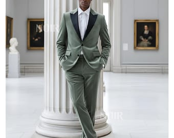 May include: A sage green velvet suit with a black satin lapel, paired with a white dress shirt and black dress shoes. The suit jacket has a two-button closure and the pants are tailored. The image is taken in a museum setting.