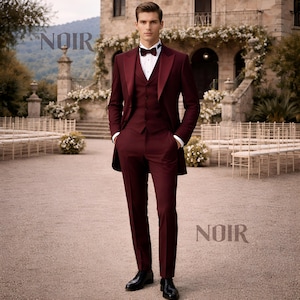 May include: A burgundy three-piece suit with a satin lapel, bow tie, and white dress shirt. The suit is worn with black dress shoes. The word "NOIR" is displayed in the upper left and lower right corners of the image.
