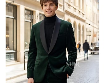 May include: A dark green velvet suit with a black lapel and a black turtleneck. The suit is tailored and has a classic design. The word "NOIR" is visible in the image.