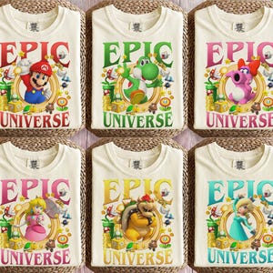 Op de afbeelding: Zes off-white t-shirts met grafische prints van videogamepersonages zoals Mario, Yoshi, Birdo, Prinses Peach, Bowser en Rosalina. Elk shirt toont de tekst EPIC UNIVERSE met kleurrijke iconen van munten, sterren en buizen.
