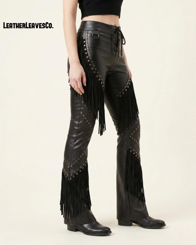 May include: Black leather trousers with fringe detailing and silver stud accents. The trousers have a lace-up front and are flared at the bottom. The brand name "LEATHERLEAVESCO." is visible in the upper left corner.