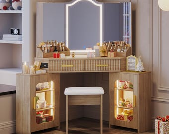 May include: A light wood vanity with a large mirror and built-in lighting. The vanity has two drawers, a stool, and two side cabinets with shelves. The mirror is framed with a white light. The vanity is decorated with small gifts and beauty products.
