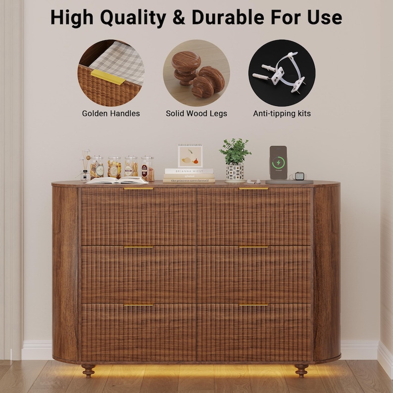 May include: A brown wooden dresser with three drawers and gold-colored handles. The dresser has solid wood legs and includes anti-tipping kits. The text "High Quality & Durable For Use" is at the top of the image.