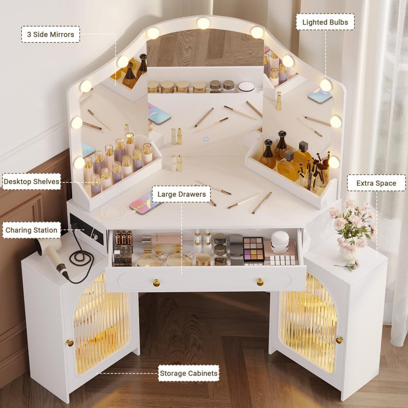 May include: White vanity table with a large mirror, lighted bulbs, and three side mirrors. Features desktop shelves, large drawers, storage cabinets, and a charging station. Includes extra space for decor.