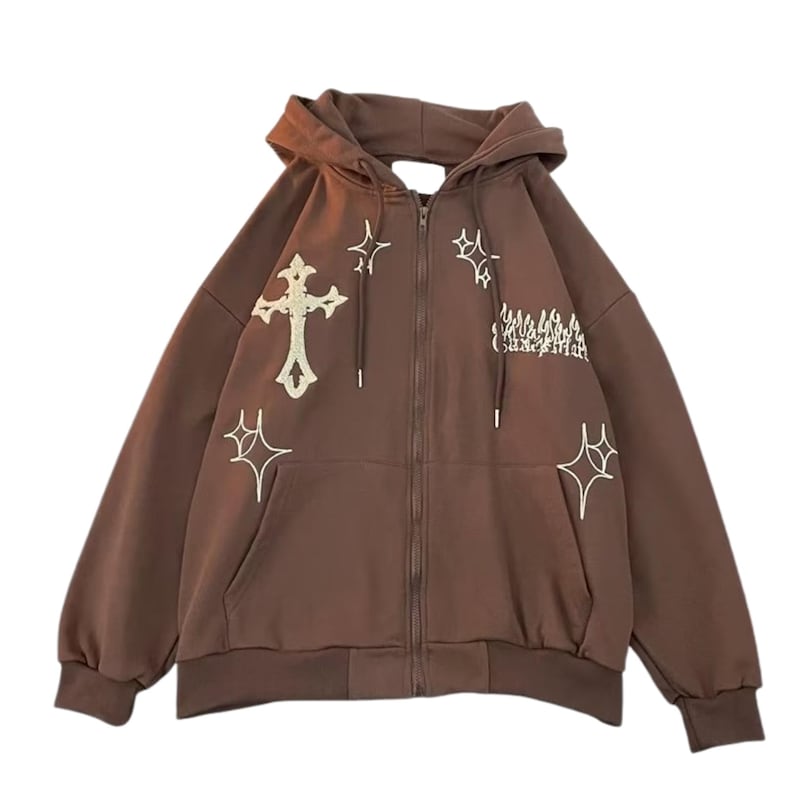 May include: A brown zip-up hoodie with a hood and front pockets. The hoodie features white embroidered crosses and starburst designs. The text on the right side of the chest is partially visible. The hoodie is made of a soft material.
