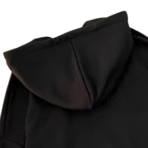 May include: A close-up of a black hooded sweatshirt. The hood is the primary focus, showcasing its shape and the fabric's texture. The image highlights the design and construction of the garment, emphasizing its dark color and casual style.