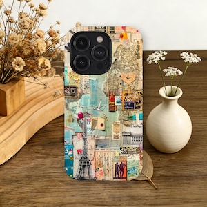 May include: A phone case featuring a collage of vintage travel-themed elements. The design includes a map, stamps, and images of the Eiffel Tower and a hot air balloon. The case has a glossy finish and a black camera module.