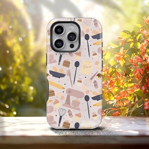 May include: A phone case with a light beige background featuring a repeating pattern of baking tools and treats. The design includes whisks, rolling pins, cupcakes, and a bag of flour. The case has a glossy finish and a camera cutout.