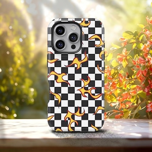 May include: A smartphone case featuring a black and white checkered pattern overlaid with scattered yellow and orange flame graphics. The case has a cutout for a triple-lens camera system on the upper left side and a smooth, flat surface.