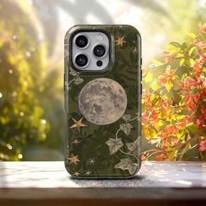 May include: A dark olive green smartphone case featuring a detailed illustration of a full moon, scattered gold-toned stars, and trailing ivy leaves. The case has a rectangular cutout at the top for the camera lenses and a smooth, matte finish.