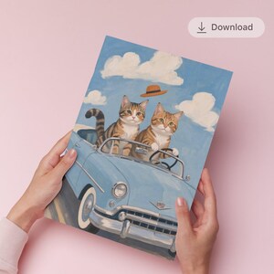 May include: An illustrated print showing two tabby cats in a light blue convertible car, set against a blue sky with white clouds. A brown hat floats above the car. The artwork has a vintage, illustrative style.