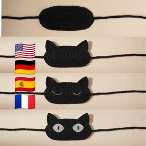 Könnte beinhalten: Schwarze Schlafmasken aus Häkelarbeit in Katzenform, verbunden durch ein schwarzes Band. Eine Maske ist oval, die anderen haben Katzenohren und geschlossene Augen. Die untere Maske hat weiße Augen. Die Masken werden vor einem neutralen Hintergrund gezeigt.