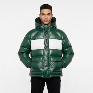 May include: Green puffer jacket with a white stripe across the chest. The jacket has a hood, two front pockets, and the brand name "Avirex" printed vertically down the center. The jacket is worn by a person.