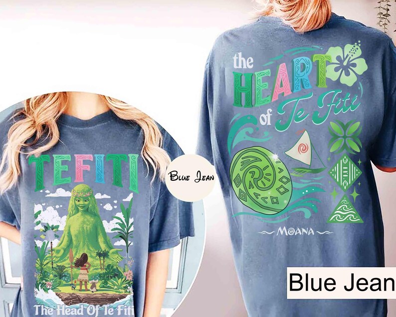 May include: Blue denim-colored t-shirts with graphics from the animated film Moana. The front features the word "TEFITI" in green, pink, and blue, with a green character and the text "The Head Of Te Fiti". The back displays "the HEART of Te Fiti" and other graphics.