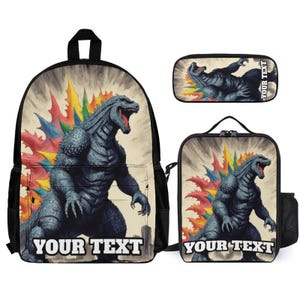 May include: A backpack, a lunch bag, and a pencil case set featuring a dark blue monster with a rainbow-colored dorsal fin. Each item displays the text YOUR TEXT in bold white letters against a beige background with a city silhouette.