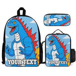 May include: A blue backpack, pencil case, and lunch bag set featuring a cartoon dinosaur design. The dinosaur is blue with red spikes and the text "YOUR TEXT" is printed on the front of each item. The background is light blue with clouds.