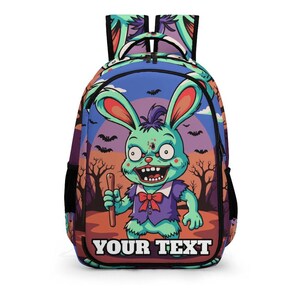 May include: A colorful backpack featuring a cartoon zombie bunny with a purple vest and red bow tie, holding a stick. The background includes bats, trees, and the text "YOUR TEXT". The backpack has black side pockets and straps.