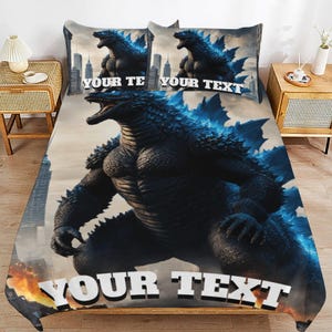 May include: A bedding set featuring a large, dark, textured monster with blue glowing accents standing in a city. The design includes two pillowcases and a comforter, all displaying the text YOUR TEXT in bold white letters against the scene.