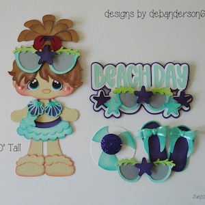 May include: A paper cutout of a mermaid-like figure, 6.0" tall, with sunglasses, a beach ball, and flip-flops. The words "Beach Day" are also included. The color scheme includes shades of blue, purple, and brown.