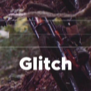 May include: A mountain bike with red and black detailing is seen in motion on a dirt track. The word "Glitch" is displayed in white, stylized text across the image, suggesting a digital or technical theme.