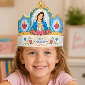 May include: A paper crown craft featuring an illustration of the Virgin Mary, pink roses, and two sacred hearts on a blue background. The text reads: My soul magnifies the Lord and my spirit rejoices in God my Savior. Luke 1:46-47. It includes gold accents.