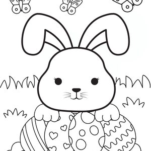 May include: A black and white line drawing of a bunny rabbit holding three Easter eggs. The bunny has large ears and a cute face. The eggs are decorated with stripes, hearts, and polka dots. There are two butterflies above the bunny.